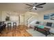 Open concept living room with stairs, wood floors, and bar stool seating at kitchen counter at 720 Earls Ct, Safety Harbor, FL 34695