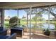 Enclosed porch with a fire pit and view of the lake at 720 Earls Ct, Safety Harbor, FL 34695