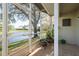 Screened porch with a view of the lake, and potted plants at 720 Earls Ct, Safety Harbor, FL 34695
