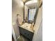 This bathroom features a gray vanity with a neutral counter, and a view to the shower at 8911 Blind Pass Rd # 220, St Pete Beach, FL 33706