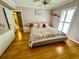 Bedroom with light pink walls and hardwood floors at 8911 Blind Pass Rd # 220, St Pete Beach, FL 33706