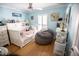 Bright bedroom with a trundle bed, gray beanbag chair, ceiling fan, and stylish decor at 8911 Blind Pass Rd # 220, St Pete Beach, FL 33706
