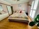 Cozy bedroom with hardwood floors, plantation shutters, and a comfortable bed with decorative pillows at 8911 Blind Pass Rd # 220, St Pete Beach, FL 33706