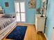 Bedroom featuring light blue walls and a window with shutters at 8911 Blind Pass Rd # 220, St Pete Beach, FL 33706