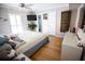 Bright bedroom with a ceiling fan, neutral walls, and light-colored wood flooring at 8911 Blind Pass Rd # 220, St Pete Beach, FL 33706