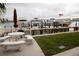 Private dock with boat slips, patio with picnic table, and waterfront views at 8911 Blind Pass Rd # 220, St Pete Beach, FL 33706
