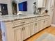 Kitchen island featuring sink, storage, light countertops, and stainless steel hardware at 8911 Blind Pass Rd # 220, St Pete Beach, FL 33706