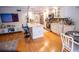 Bright renovated kitchen featuring an island, white cabinets, stainless appliances, and a tiled backsplash at 8911 Blind Pass Rd # 220, St Pete Beach, FL 33706