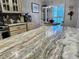 Eat-in kitchen with granite countertops, stainless steel appliances, and custom cabinetry at 8911 Blind Pass Rd # 220, St Pete Beach, FL 33706