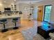 Open floor plan living area featuring bar seating, dining area, and a front door with outside access at 8911 Blind Pass Rd # 220, St Pete Beach, FL 33706