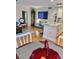 Open concept living area combines seating and kitchen with a large TV on the wall at 8911 Blind Pass Rd # 220, St Pete Beach, FL 33706