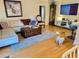 Cozy living room with hardwood floors, comfortable seating and a dog at 8911 Blind Pass Rd # 220, St Pete Beach, FL 33706