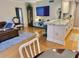 Open concept living and kitchen area with TV and bar stool seating at 8911 Blind Pass Rd # 220, St Pete Beach, FL 33706
