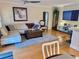 Open concept living room with flat screen TV and kitchen at 8911 Blind Pass Rd # 220, St Pete Beach, FL 33706
