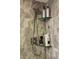 Modern shower featuring gray tiled walls, glass shelving, and an adjustable shower head at 8911 Blind Pass Rd # 220, St Pete Beach, FL 33706