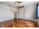 Open bedroom space featuring hardwood floors, a ceiling fan, and closet space at 13153 Kings Crossing Dr, Gibsonton, FL 33534