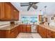 Charming kitchen boasting granite countertops, wood cabinets, stainless steel appliances, and a view to the outside at 1327 51St Ne Ave, St Petersburg, FL 33703