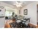 Cozy dining area featuring a glass-top table, wrought iron chairs, and direct access to the living room at 14336 93Rd Ave, Seminole, FL 33776