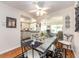 Dining room with a glass-top table, wrought iron chairs, and seamless connection to the kitchen and living room at 14336 93Rd Ave, Seminole, FL 33776