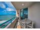 Relaxing balcony with an outdoor dining area, offering stunning panoramic ocean views at 1520 Gulf Blvd # 1407, Clearwater Beach, FL 33767