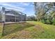 Grassy backyard showing a lovely lawn with multiple screen enclosed lanais at 16010 Gatwick Ct, Tampa, FL 33647