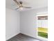 Bright bedroom with gray flooring and fan with a view of the backyard at 17736 Rivendel Rd, Lutz, FL 33549