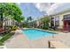 Community pool with lounge chairs and tropical landscaping, perfect for relaxation on a sunny day at 2001 E 2Nd Ave # 20, Tampa, FL 33605