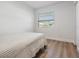 Neutral bedroom with hardwood floors, and an awning style window at 2004 N Grady Ave, Tampa, FL 33607