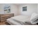 Well-lit bedroom with a platform bed, neutral color scheme, and wide-slat blinds at 2004 N Grady Ave, Tampa, FL 33607
