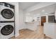 Open concept kitchen with modern appliances, white cabinets, and a washer and dryer at 2004 N Grady Ave, Tampa, FL 33607