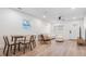 Bright living room and dining room with hardwood floors, a ceiling fan, and a modern table at 2004 N Grady Ave, Tampa, FL 33607