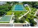 Overhead view of the community recreational area with tennis courts, shuffleboard, and manicured landscaping at 2042 Australia W Way # 66, Clearwater, FL 33763