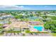 Aerial shot showcasing community amenities: pool, tennis courts, recreation center, and lush landscaping at 2042 Australia W Way # 66, Clearwater, FL 33763