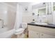 Functional bathroom with a tiled tub and shower combination, toilet and vanity with a mirror above at 2042 Australia W Way # 66, Clearwater, FL 33763