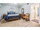 A cozy bedroom with light blue walls, dark wood furniture and a bed featuring blue decorative pillows and starfish accents at 2042 Australia W Way # 66, Clearwater, FL 33763