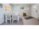 The dining room features a small dining set, gray carpet and neutral decor at 2042 Australia W Way # 66, Clearwater, FL 33763