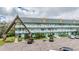 Three-story condo building with balconies, parking lot, and attractive architecture at 2042 Australia W Way # 66, Clearwater, FL 33763