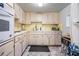 A view of the kitchen featuring white appliances and countertops at 2042 Australia W Way # 66, Clearwater, FL 33763