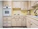 Well-maintained kitchen with white oven, countertops, and ample cabinet space at 2042 Australia W Way # 66, Clearwater, FL 33763