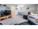 Bright living area with carpet, television, and adjacent dining space at 2042 Australia W Way # 66, Clearwater, FL 33763