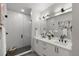 Modern bathroom featuring a glass shower and double vanity with sleek, black fixtures and white cabinets at 2209 16Th N St, St Petersburg, FL 33704