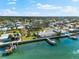 Waterfront property boasting a private boat dock, verdant lawn, and easy access to the open water and community at 2210 Harbor View Dr, Dunedin, FL 34698