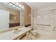 Bathroom featuring a marbled sink vanity and a tub and shower combination at 2220 Spanish Dr # 4, Clearwater, FL 33763