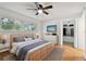 Well-lit bedroom featuring a wooden bed frame, large window, and closet, and hardwood floors at 2220 Spanish Dr # 4, Clearwater, FL 33763
