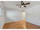 Bright bedroom featuring wood floors, a ceiling fan, and a closet with white doors at 2220 Spanish Dr # 4, Clearwater, FL 33763