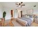 Spacious bedroom featuring a wooden bed frame, hardwood floors, and an ensuite bathroom with storage at 2220 Spanish Dr # 4, Clearwater, FL 33763