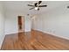 Spacious bedroom featuring gleaming wood floors, ceiling fan, and ensuite bath at 2220 Spanish Dr # 4, Clearwater, FL 33763