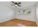 Bedroom featuring hardwood floors, a ceiling fan, and a window view of a beautiful tree at 2220 Spanish Dr # 4, Clearwater, FL 33763