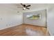 Bedroom featuring hardwood floors, a ceiling fan, and a window, creating a comfortable atmosphere at 2220 Spanish Dr # 4, Clearwater, FL 33763