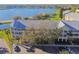 Aerial view of a yellow building near a parking lot, trees, and waterfront at 2220 Spanish Dr # 4, Clearwater, FL 33763